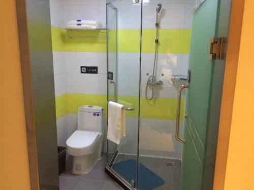 a bathroom with a toilet and a glass shower at 7 Days Inn Beijing Shunyi Development Area Mordern Motor City in Beijing