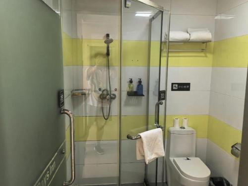 a bathroom with a glass shower with a toilet at 7 Days Inn Beijing Shunyi Development Area Mordern Motor City in Beijing