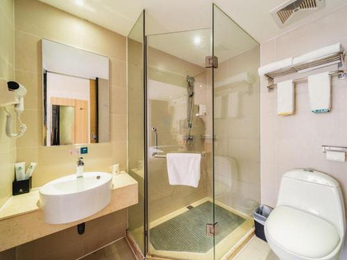 a bathroom with a sink and a toilet and a shower at City Comfort Inn Zhongshan Lihe Square Walmart Branch in Zhongshan