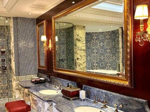 a bathroom with two sinks and a large mirror at Tongxiang Inspirock Hotel in Jiaxing