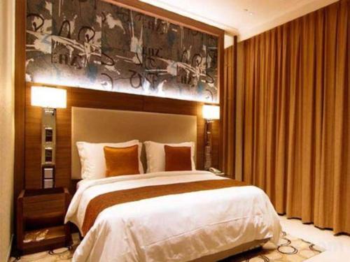 a bedroom with a large bed and a painting on the wall at Jai Alai Hotel in Macau