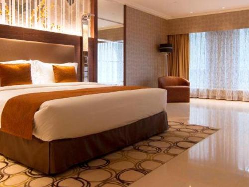 a bedroom with a large bed in a room at Jai Alai Hotel in Macau