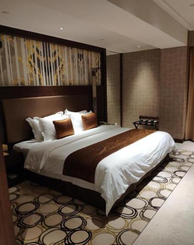 a bedroom with a large bed in a hotel room at Jai Alai Hotel in Macau