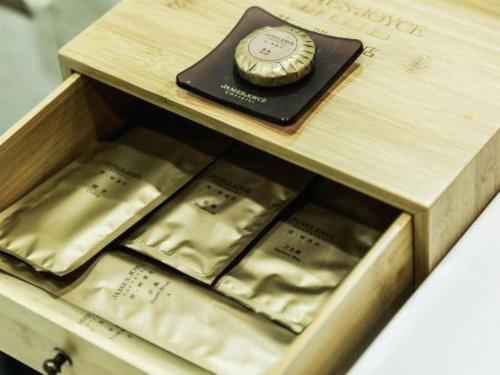 a wooden box with a watch on top of it at James Joyce Coffetel Baoding Railway Station in Baoding