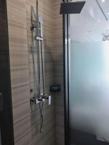 a shower with a glass door in a bathroom at Xana Hotelle Xi'an GONG IP South Gate of Zhonglou in Xi'an