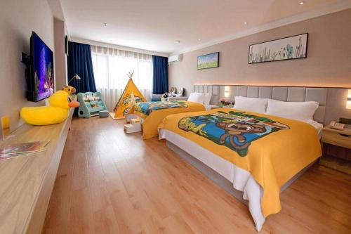 a bedroom with a large bed with a large yellow bedspread at danfeng kelly hotel in Shenzhen