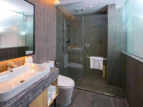 a bathroom with a sink and a toilet and a shower at danfeng kelly hotel in Shenzhen