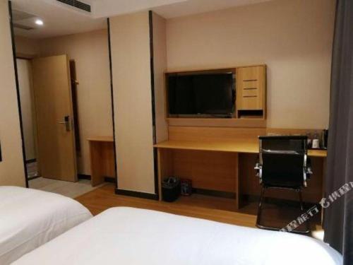 Ένα ή περισσότερα κρεβάτια σε δωμάτιο στο 7 Days Premium Qingdao World of Ocean Qingdao University