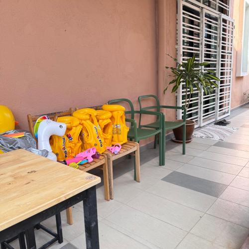 a bunch of yellow shirts sitting on a bench at Cahaya Melissa Homestay Private Pool in Melaka