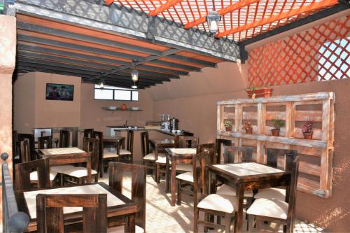 - un restaurant avec des tables et des chaises en bois dans une chambre dans l'établissement Hostal Valle Mistral, à La Serena