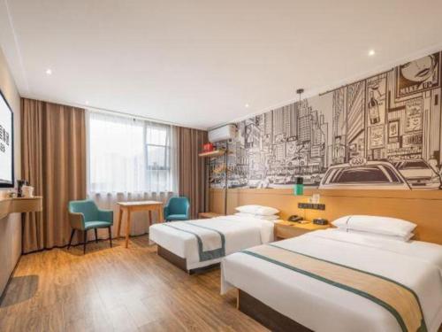 a hotel room with two beds and a desk at City Comfort Inn Xiantao Avenue Wangzhou Bridge Wushang in Xiantao