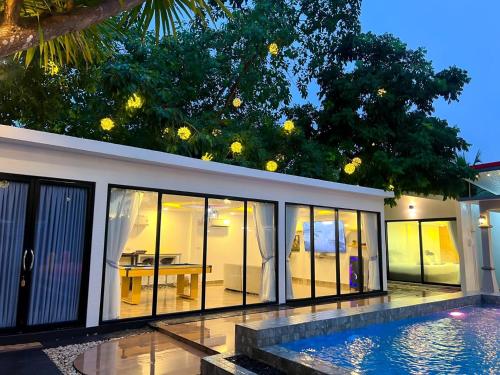 a house with a swimming pool in front of it at VS PoolVilla in Ban Thang Khun