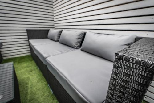 a couch with pillows sitting in a room at Bellevue Apartments Middlesborough in Middlesbrough