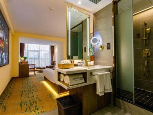 a bathroom with a sink and a shower at James Joyce Coffetel· Xianyang Renmin Road Central Square Store in Xianyang