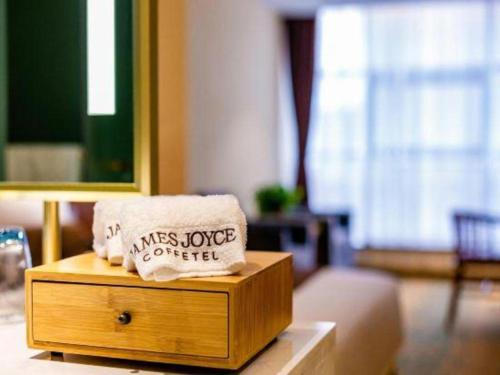 a wooden box with a pillow on top of it at James Joyce Coffetel· Xianyang Renmin Road Central Square Store in Xianyang