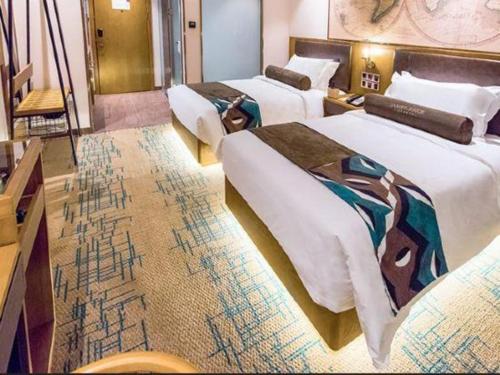 a hotel room with three beds and a carpet at James Joyce Coffetel Changchun People's Square in Changchun