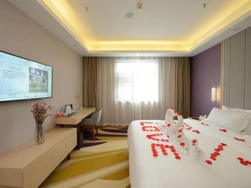 a hotel room with a bed with red decorations on it at Lavande Hotels Wuhan Guanggu Yangjiawan Metro Station in Wuhan