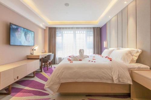 a hotel room with a bed with roses on it at Lavande Hotels Wuhan Guanggu Yangjiawan Metro Station in Wuhan