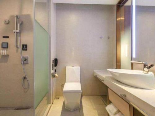 a bathroom with a sink and a shower at Lavande Hotels Wuhan Guanggu Yangjiawan Metro Station in Wuhan
