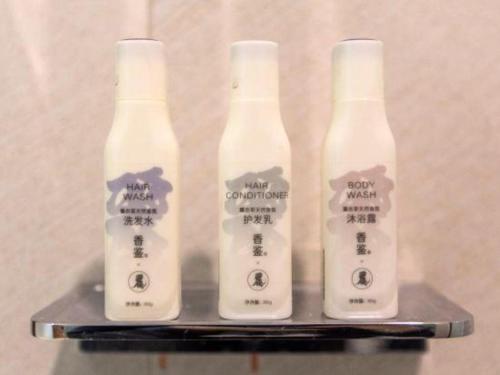 three bottles of moisturizers sitting on a shelf at Lavande Hotels Wuhan Guanggu Yangjiawan Metro Station in Wuhan