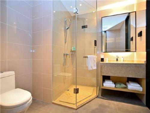a bathroom with a shower and a toilet and a sink at City Comfort Inn Kunming High Speed Railway South Station Yongxin Harvard in Kunming