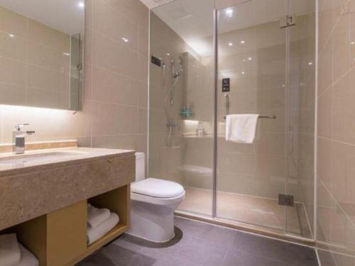 a bathroom with a shower and a toilet and a sink at City Comfort Inn Kunming High Speed Railway South Station Yongxin Harvard in Kunming