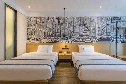 two beds in a room with a mural of a city at City Comfort Inn Kunming High Speed Railway South Station Yongxin Harvard in Kunming