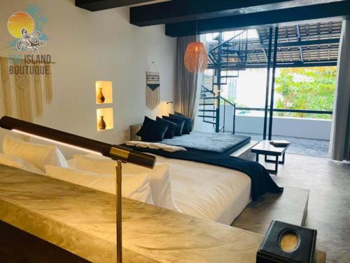 a bedroom with two beds and a large window at Tao Island Boutique Hotel in Koh Tao