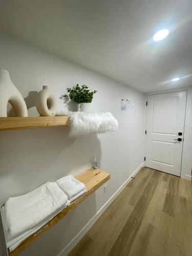 a room with a shelf with towels and a door at Your Cozy Happy Place in Calgary