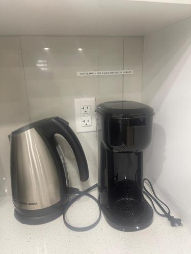 a coffee maker and a toaster sitting on a counter at Your Cozy Happy Place in Calgary