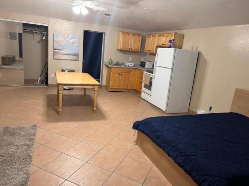 a kitchen with a table and a white refrigerator at Downtown Pool Suite 2 in Phoenix