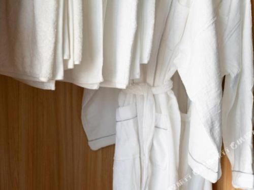 a close up of white curtains on a bed at Venus Royal Hotel Nanning East High-Speed Railway Station in Nanning