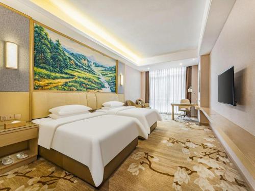 Giường trong phòng chung tại Venus International Hotel Guangdong Foshan Longjiang Exhibition Center 2nd Branch