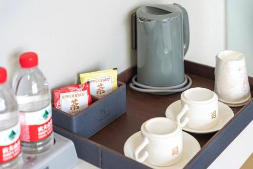 a shelf with two cups and a blender on it at Borrman Hotel Jining High-tech Huangtun in Jining