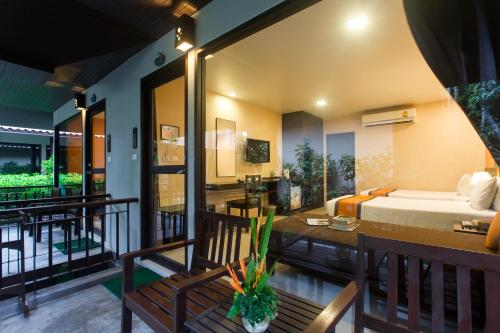 a room with a bed and a balcony at Baan Chaweng Beach Resort & Spa - SHA Extra Plus in Chaweng