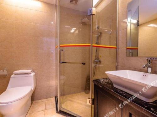 a bathroom with a toilet and a shower and a sink at Super 8 Hotel Guiyang Qianling Park Ruijin North Road in Guiyang