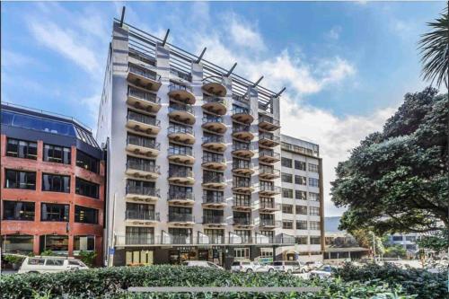 a large white building with a lot of balconies at CBD Apartment in Wellington