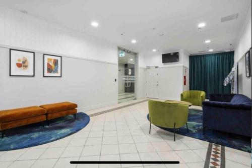 a living room with a couch and a table and chairs at CBD Apartment in Wellington