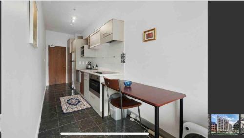a small kitchen with a table and a counter at CBD Apartment in Wellington