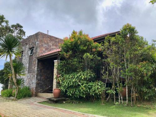 a brick house with trees in front of it at The Jerai Hill Resort in Yan