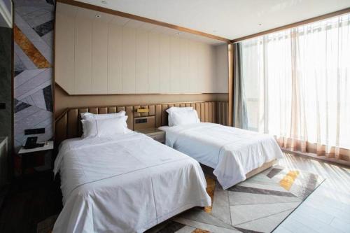 Katil atau katil-katil dalam bilik di Tomeet Hotel