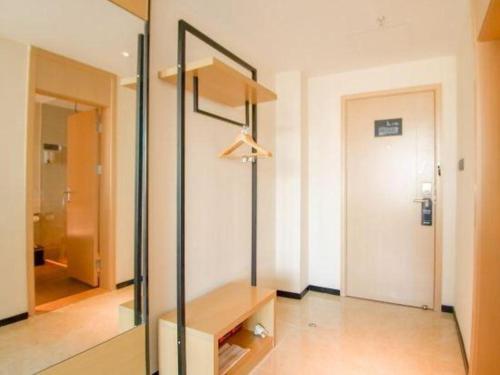 a dressing room with a table and a mirror at City Comfort Inn Haikou Zhongjie Road Walking Street in Haikou