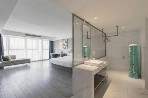 a bathroom with a bed and a sink in a room at 7 Days Premium Hotel Chongqing Jiangbei International Airport Terminal 3 in Chongqing