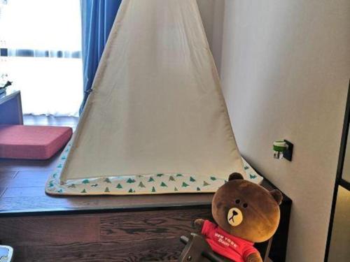 a teddy bear is sitting in front of a tent at Xiamen Seashine Lakeview Hotel in Xiamen