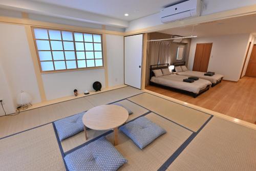 a large room with a bed and a table and a bedroom at Skytree Luxury Villa - 2025 New, to Skytree, Direct Airport Access in Tokyo