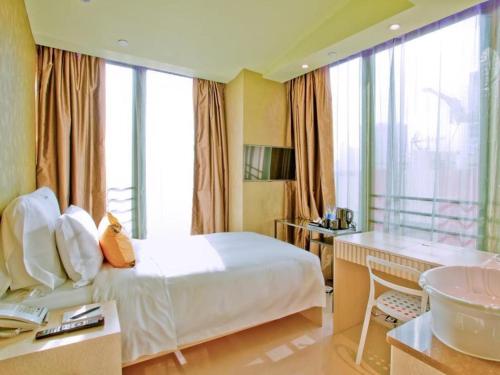 a hotel room with a bed and a sink at Harbour Bay Hotel in Hong Kong