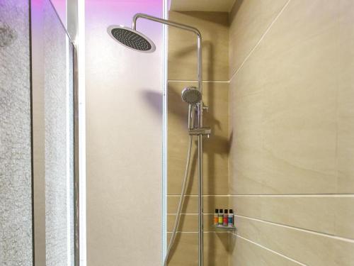 a shower with a glass door in a bathroom at Harbour Bay Hotel in Hong Kong