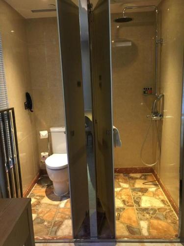 a bathroom with a shower and a toilet at Harbour Bay Hotel in Hong Kong