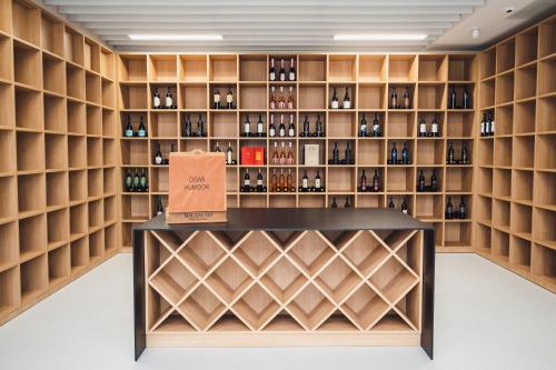 a wine tasting room with shelves of wine bottles at Akademis - Fit Split in Split