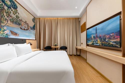 Postel nebo postele na pokoji v ubytování Shenzhen-Hong Kong Hui Hotel, Futian Port Convention and Exhibition Center